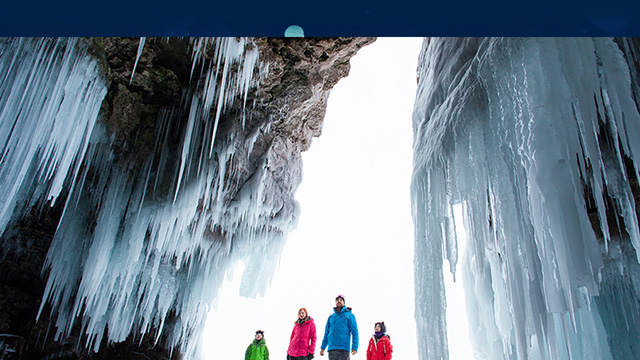 Family exploring ice cave