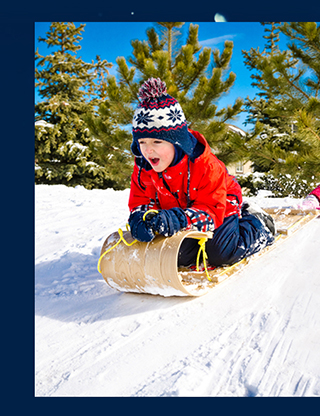 Child sledding through the snow