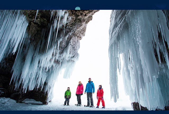 Family exploring ice cave mobile